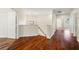 Upper hallway showcasing hardwood flooring and natural light from the window above the staircase at 587 Lakewood Dr, Oldsmar, FL 34677