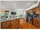 Well-lit kitchen with a granite island, stainless steel appliances, and ample counter space for cooking and entertaining at 587 Lakewood Dr, Oldsmar, FL 34677