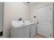 Functional laundry room with washer and dryer, offering convenient space for laundry tasks at 587 Lakewood Dr, Oldsmar, FL 34677