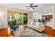 Bright living room features a ceiling fan and sliding glass doors leading to the outdoor space at 587 Lakewood Dr, Oldsmar, FL 34677