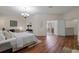 Spacious main bedroom with hardwood floors, a chandelier, and ensuite bath access at 587 Lakewood Dr, Oldsmar, FL 34677