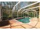 Relaxing screened-in pool area features a spa and brick-paved patio perfect for lounging outdoors at 587 Lakewood Dr, Oldsmar, FL 34677