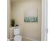Cozy powder room featuring tasteful artwork, neutral walls, and simple fixtures, creating a serene space at 587 Lakewood Dr, Oldsmar, FL 34677