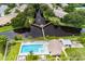 Beautiful aerial view of a community pool and gazebo over the pond, surrounded by lush greenery and manicured landscaping at 6210 92Nd N Pl # 3405, Pinellas Park, FL 33782