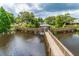 Scenic wooden bridge leading to a charming gazebo on the lake in a tranquil and picturesque community at 6210 92Nd N Pl # 3405, Pinellas Park, FL 33782