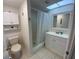Neat bathroom with a walk-in shower and vanity, features clean lines and bright lighting at 7050 Sunset S Dr # 208, South Pasadena, FL 33707