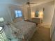 Bright and airy bedroom with a ceiling fan, comfortable bed, and well-lit dressing area at 7050 Sunset S Dr # 208, South Pasadena, FL 33707