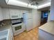 Functional kitchen with ample cabinet space, white appliances, and easy access to the dining area at 7050 Sunset S Dr # 208, South Pasadena, FL 33707