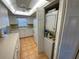 Efficient kitchen layout with white cabinetry and appliances, plus a convenient in-unit washer and dryer at 7050 Sunset S Dr # 208, South Pasadena, FL 33707