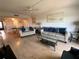 Inviting living room with neutral furnishings and bright accents, showcasing open layout into the dining area at 7050 Sunset S Dr # 208, South Pasadena, FL 33707