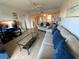 Comfortable living room features modern entertainment setup and clear view of the adjacent dining area at 7050 Sunset S Dr # 208, South Pasadena, FL 33707