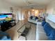 Cozy living room features contemporary furnishings and bright, open spaces that connects to the dining area at 7050 Sunset S Dr # 208, South Pasadena, FL 33707