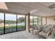 Meeting room overlooking the pool and surrounding greenery through expansive windows at 7050 Sunset S Dr # 208, South Pasadena, FL 33707