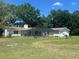Spacious backyard with screened porch, horses grazing in the yard, offering a peaceful rural setting at 3009 Jim Johnson Rd, Plant City, FL 33566