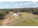 Spacious barn in a rural setting, ideal for horses and livestock; surrounded by trees and fencing at 3009 Jim Johnson Rd, Plant City, FL 33566