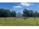 Well maintained barn in fenced pasture with donkeys grazing at 3009 Jim Johnson Rd, Plant City, FL 33566