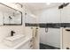 Modern bathroom features a glass shower, white vanity, and black fixtures at 3009 Jim Johnson Rd, Plant City, FL 33566