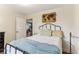 Cozy bedroom showcasing a black iron bed frame and wooden world map wall decor at 3009 Jim Johnson Rd, Plant City, FL 33566