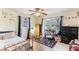Bright bedroom with ceiling fan, hardwood floors, and views of the outdoors at 3009 Jim Johnson Rd, Plant City, FL 33566