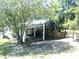 Exterior image of a horse barn featuring multiple stalls and shaded areas for livestock at 3009 Jim Johnson Rd, Plant City, FL 33566