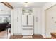 Bright kitchen featuring a modern refrigerator and custom white cabinets for ample storage space at 3009 Jim Johnson Rd, Plant City, FL 33566