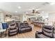 Open-concept living area with modern lighting, wood beam accent, and a view into the kitchen at 3009 Jim Johnson Rd, Plant City, FL 33566