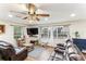 Cozy living room featuring a large window, wood floors, and comfortable seating at 3009 Jim Johnson Rd, Plant City, FL 33566