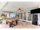Enclosed patio area featuring a dining area, hanging chair, and outdoor TV at 3009 Jim Johnson Rd, Plant City, FL 33566