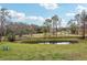 A tranquil pond, with chairs to relax and admire the serene landscape at 3009 Jim Johnson Rd, Plant City, FL 33566
