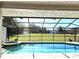 Screened-in pool with view of the backyard, barn and fenced pasture at 3009 Jim Johnson Rd, Plant City, FL 33566