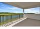 Balcony with black metal railing, water views, and bright sunshine at 8421 Golden Beach Ct, Parrish, FL 34219