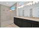 Modern bathroom featuring double sinks with gold fixtures and a glass shower at 8421 Golden Beach Ct, Parrish, FL 34219