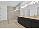 Modern bathroom featuring double sinks with gold fixtures and a glass shower at 8421 Golden Beach Ct, Parrish, FL 34219