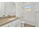 Bathroom featuring a quartz countertop vanity, white cabinets, a shower-tub combination, and a window at 8421 Golden Beach Ct, Parrish, FL 34219