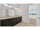 Modern bathroom featuring double sinks, marble countertops, and stylish lighting fixtures at 8421 Golden Beach Ct, Parrish, FL 34219