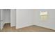 A bedroom featuring stylish laminate floors, ample natural light, and neutral paint tones at 8421 Golden Beach Ct, Parrish, FL 34219
