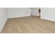 Bedroom with wood flooring, white walls, and doors leading to other rooms in the house at 8421 Golden Beach Ct, Parrish, FL 34219