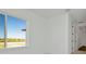 Bright bedroom with neutral carpet, white walls, and large windows offering community views at 8421 Golden Beach Ct, Parrish, FL 34219