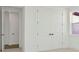Bedroom with double door closet, neutral carpet, white walls, and a view to another room at 8421 Golden Beach Ct, Parrish, FL 34219