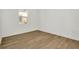 A bedroom featuring stylish laminate floors, ample natural light, and neutral paint tones at 8421 Golden Beach Ct, Parrish, FL 34219