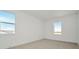 Bright bedroom with neutral carpet, white walls, and two windows offering natural light at 8421 Golden Beach Ct, Parrish, FL 34219
