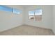 Well-lit room featuring two windows that offer a view of the exterior and carpet flooring at 8421 Golden Beach Ct, Parrish, FL 34219
