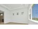 Well-lit bedroom featuring tray ceilings, wood flooring, and bright windows at 8421 Golden Beach Ct, Parrish, FL 34219