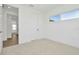 Bedroom featuring a view into the hallway, carpet flooring, and a window at 8421 Golden Beach Ct, Parrish, FL 34219