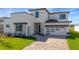 Beautiful home featuring modern architecture, a two-car garage, stone accents, and well-manicured landscaping at 8421 Golden Beach Ct, Parrish, FL 34219
