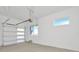 Spacious garage with an automatic door opener and bright natural light from the window at 8421 Golden Beach Ct, Parrish, FL 34219