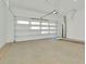 Clean and spacious garage featuring a white paneled door and concrete floor at 8421 Golden Beach Ct, Parrish, FL 34219