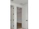 Hallway featuring white walls, white doors, and wood flooring at 8421 Golden Beach Ct, Parrish, FL 34219