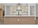 Kitchen island featuring white countertop and stylish pendant lights, with modern appliances at 8421 Golden Beach Ct, Parrish, FL 34219