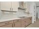 New kitchen with white countertops, decorative backsplash and modern vent hood at 8421 Golden Beach Ct, Parrish, FL 34219